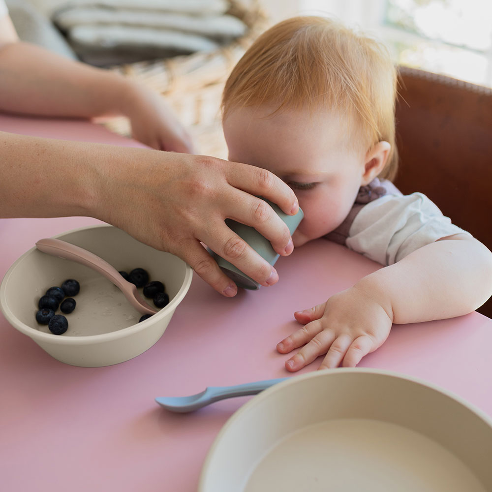 baby drinking from bibs mealtime cup