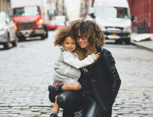 Woman and child influencers on cobbled street