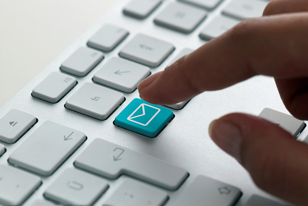 A finger about to press a button on a keyboard