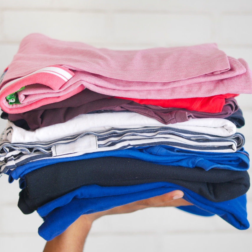 Pile of clothes being held up on someone's hand