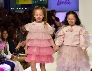 Two girls wearing pink dresses on the BLE 2022 catwalk