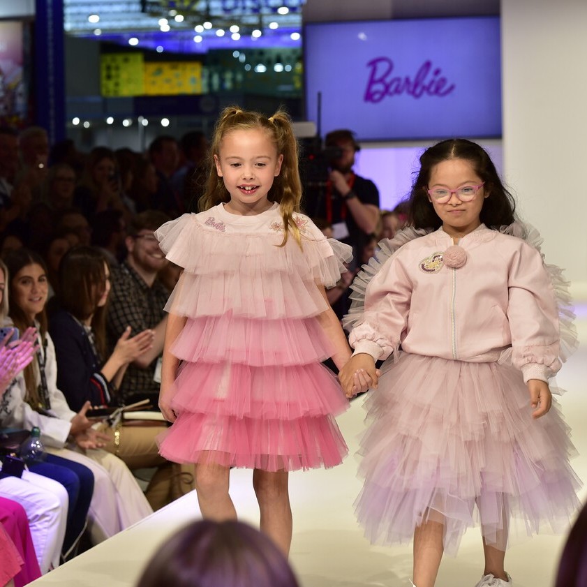 Two girls wearing pink dresses on the BLE 2022 catwalk