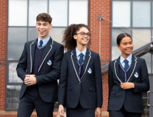 Three pupils walking wearing school uniform - the Schoolwear Association