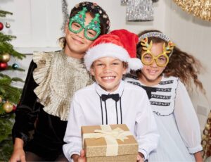 Three children dressed for Christmas