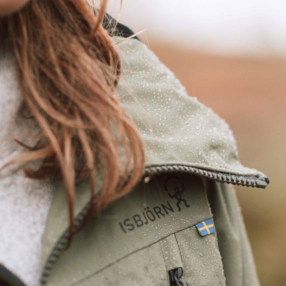 Close up of a girl wearing a pale khaki Isbjorn of Sweden coat 