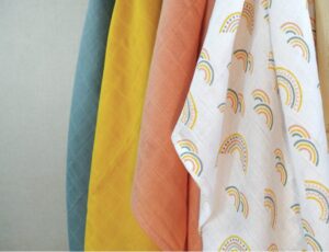 Four Rainbow Scandi muslin cloths hung up