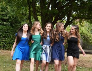 Girls stood outside in a row wearing new tween occasionwear brand Sass & Sparkle