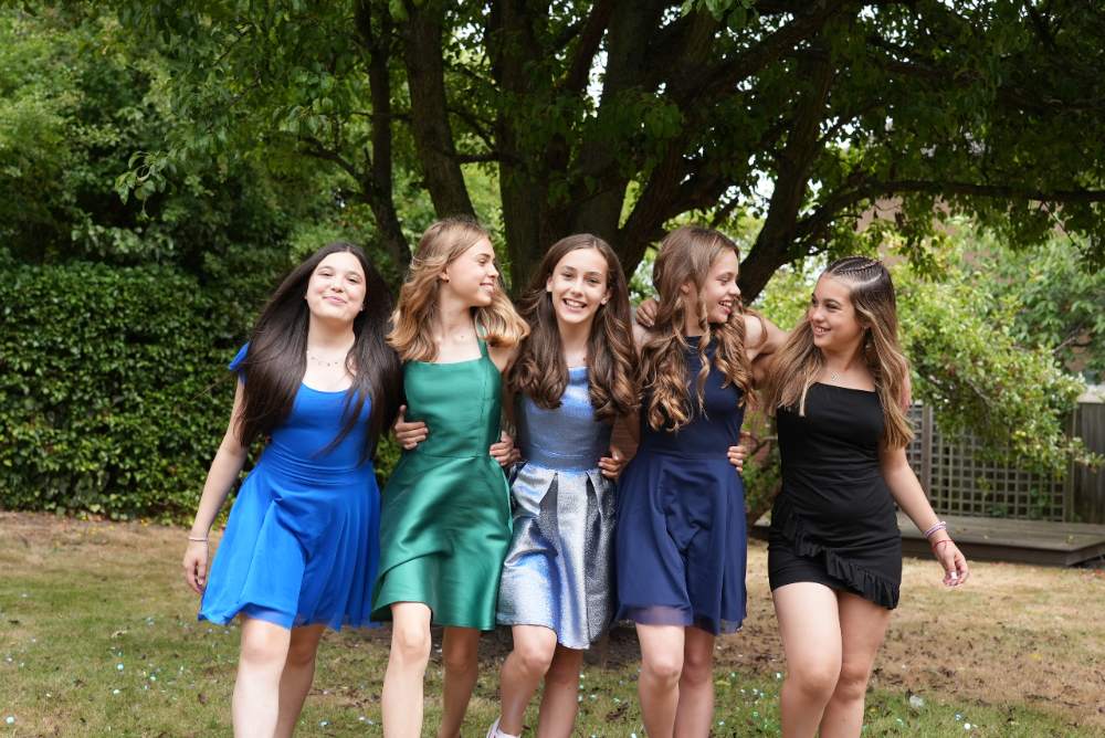 Girls stood outside in a row wearing new tween occasionwear brand Sass & Sparkle