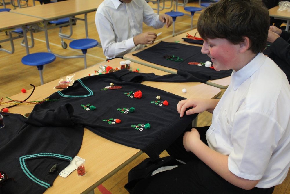 School children decorating jumpers for Christmas Jumper Day