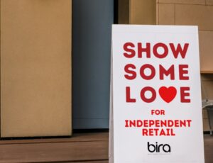 Billboard outside a shop that reads Show Some Love For Independent Retail - BIRA