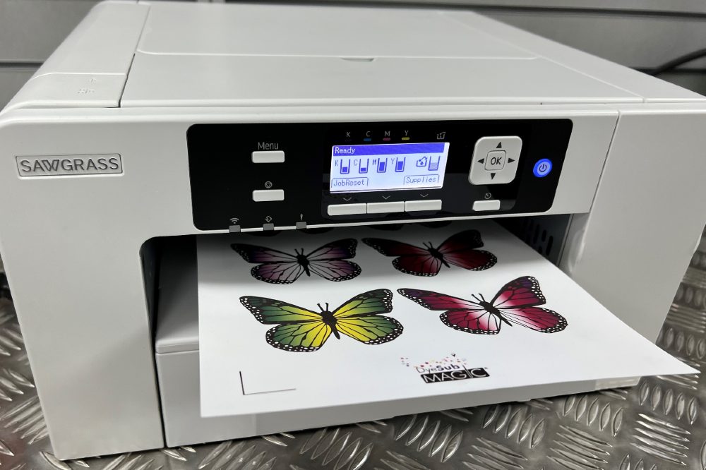 Printer with a piece of paper in the tray of butterflies