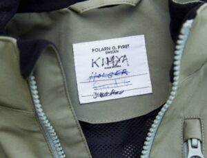 Close up of a Polarn O.Pryet child's coat showing a name label with numerous names written on it