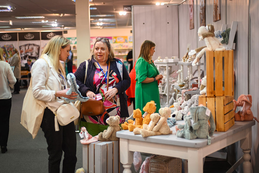 Visitors looking at plush toys on a exhibition stand