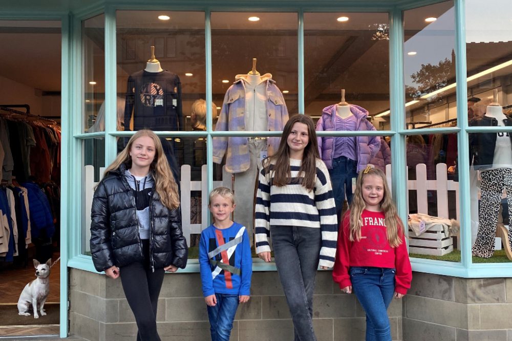Four children stood outside the Young Nant Kids Wear shop