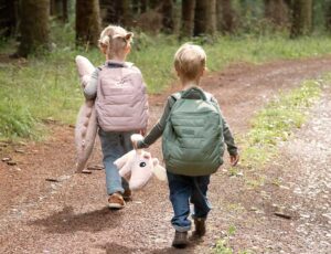 Girl and boy walking though woodland wearing quilted backpack's