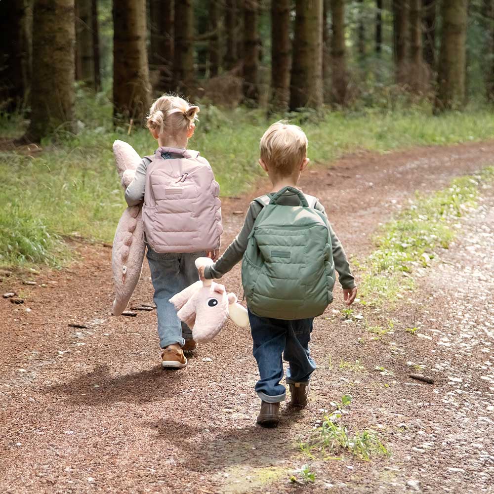 Girl and boy walking though woodland wearing quilted backpack's