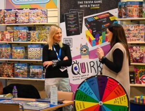 Two women stood on a stand at INDX Toy & Gift show
