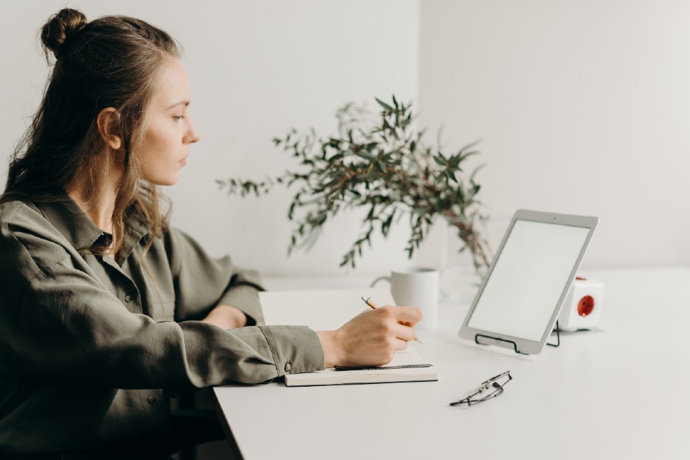 Woman sat at a desk working on a laptop