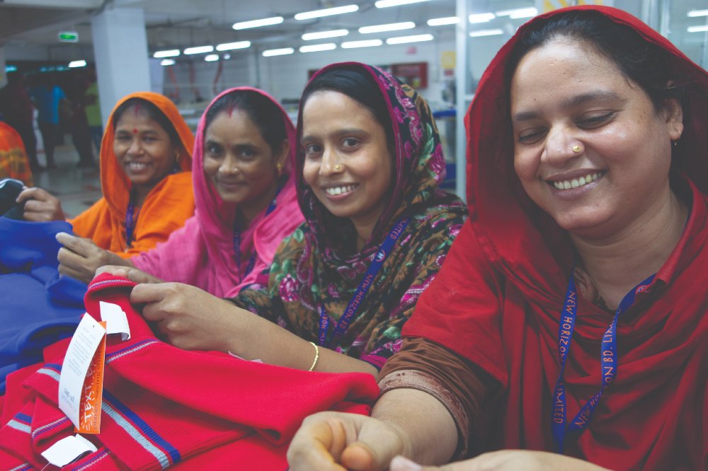Women in a factory making One+All schoolwear garments