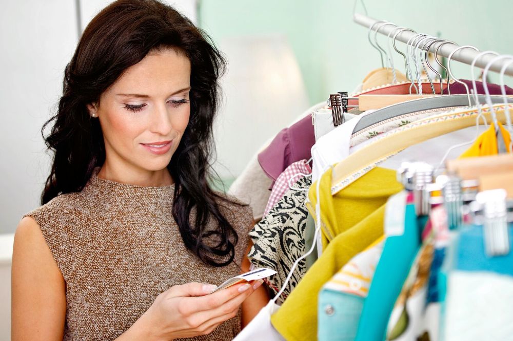 Woman looking at a label on clothing - SGS environmental claims and labelling updates