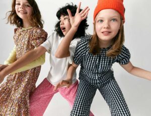 Three young girls stood together wearing new tween collection by John Lewis