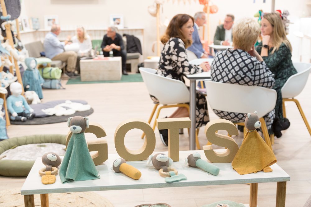 People sat on an exhibitor's stand at Kind + Jugend