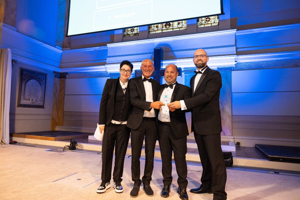 People stood on a stage receiving the High Street Hero award