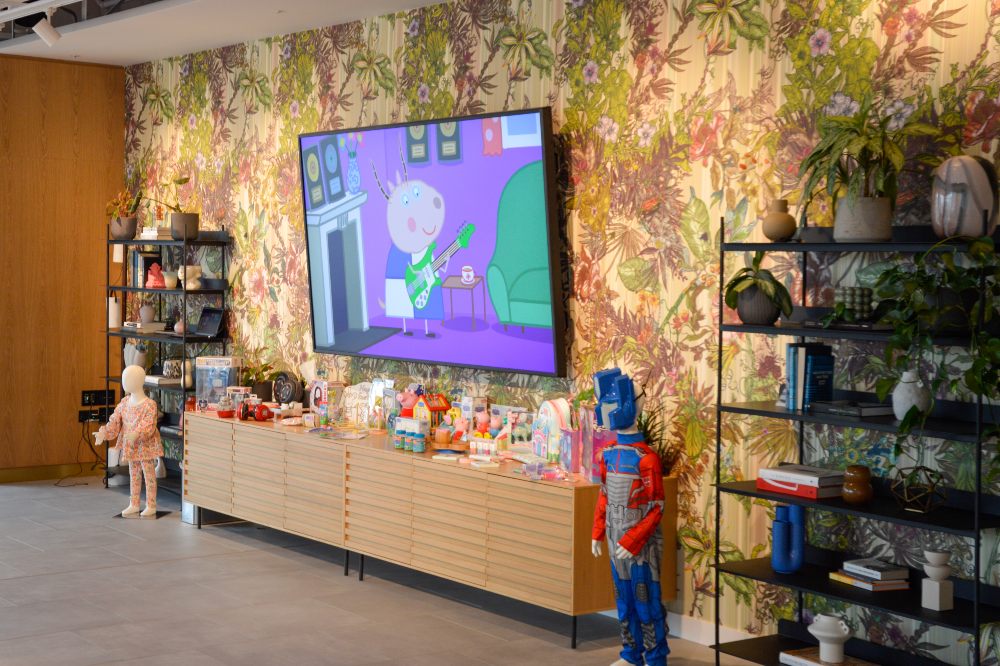 A display of children's products in a room with a screen on the wall