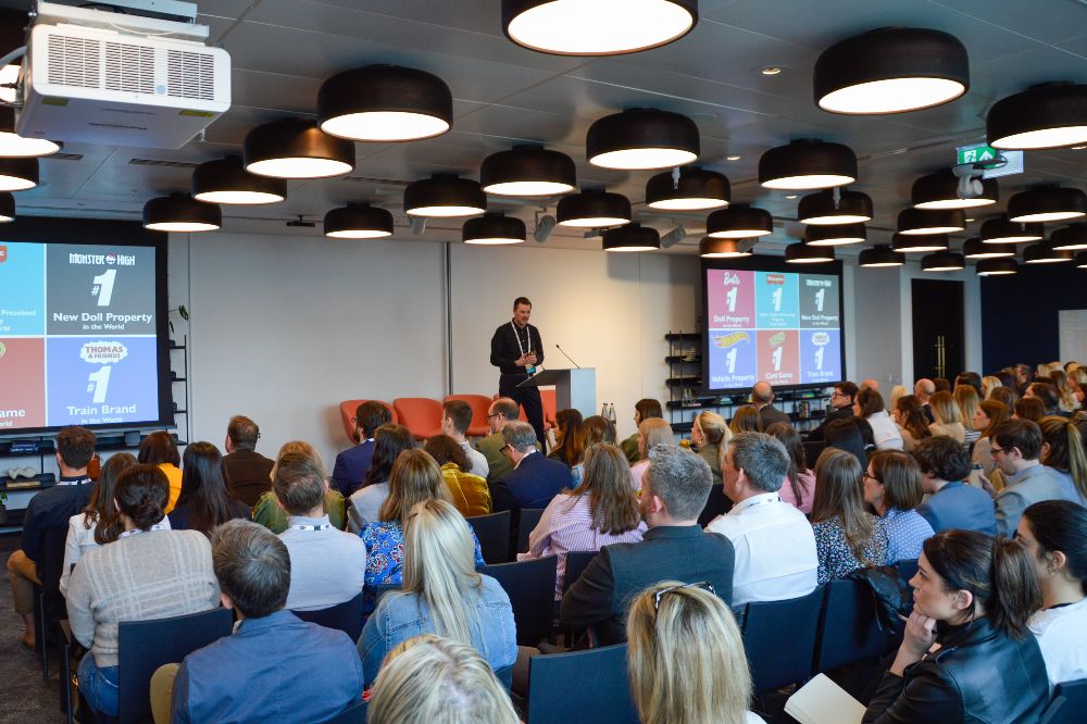 People sat in a room watching someone present a seminar