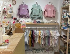 Children's clothes and accessories displayed in a shop