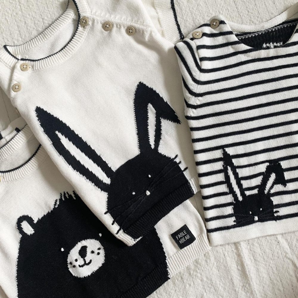 Three black and white children's tops with rabbits and a bear on 
