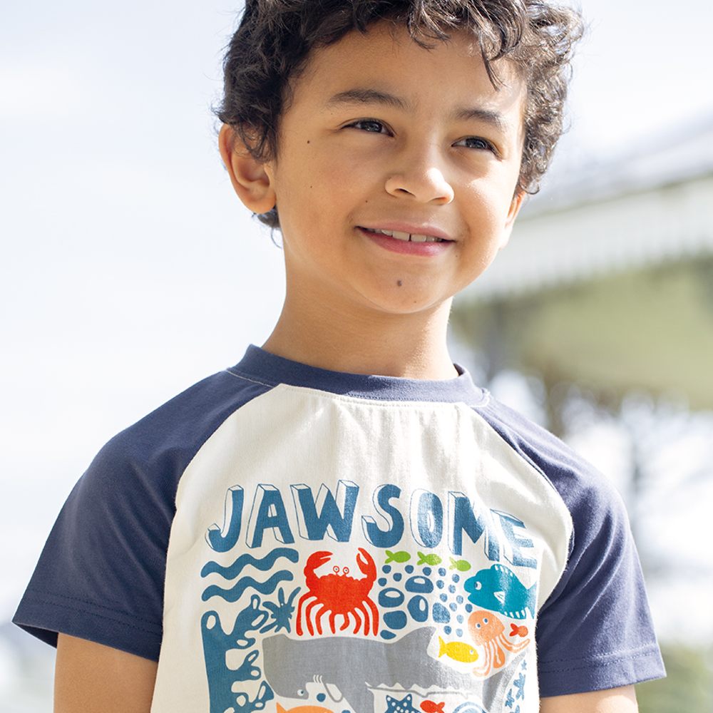 Young boy wearing a T-shirt with sea creatures on it 