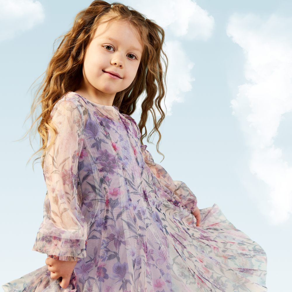 Young girl wearing a floaty lilac patterned dress 