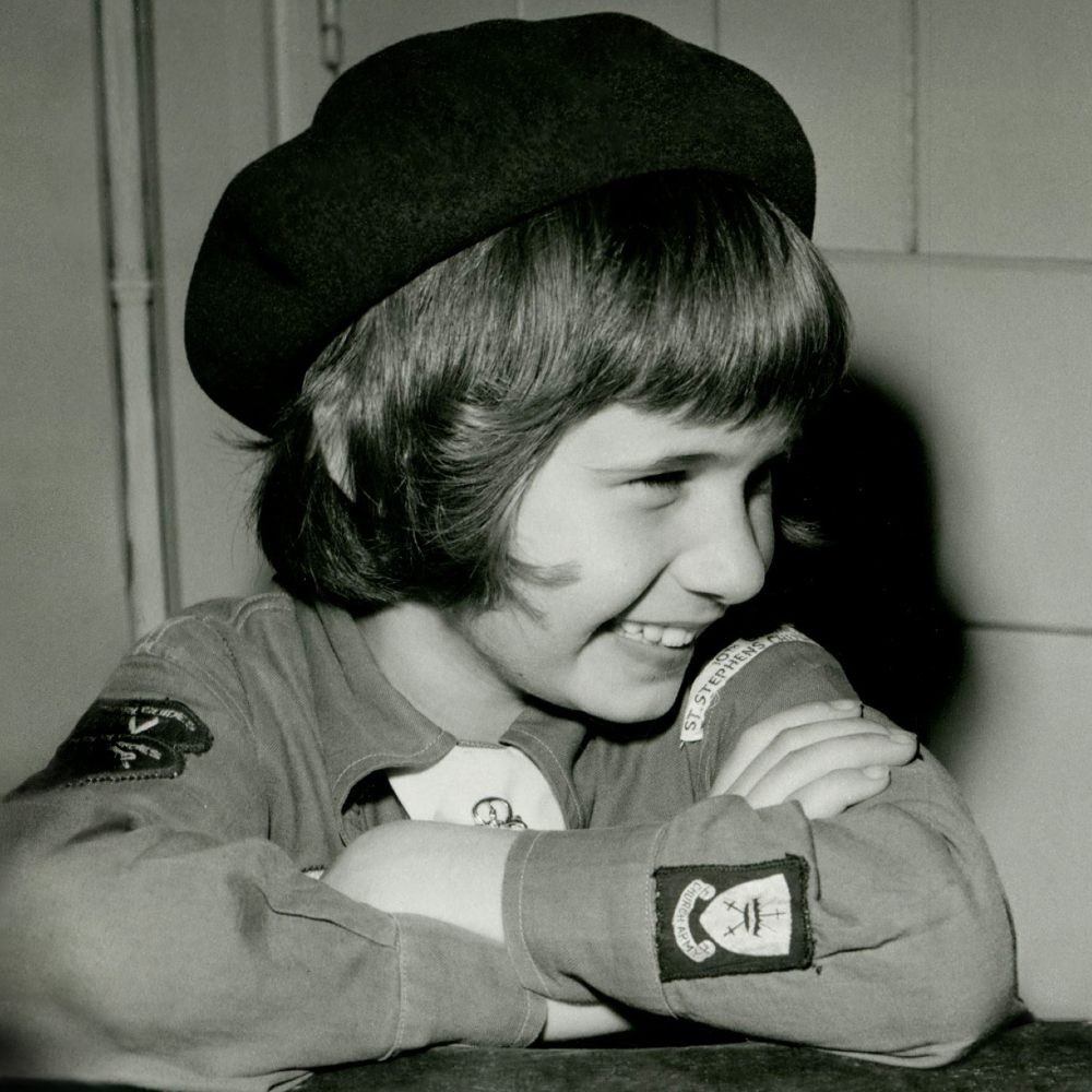Black and white images of a young girl wearing a Brownies uniform 