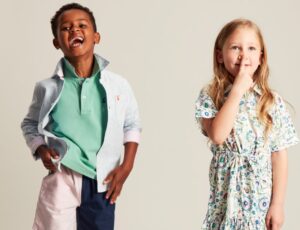 Two children wearing Joules childrenswear laughing at the camera