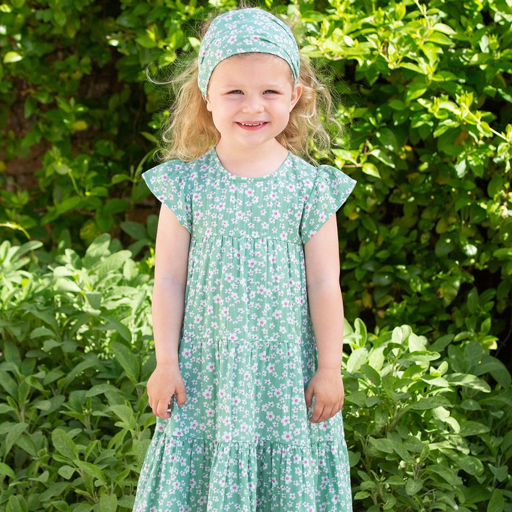 Young girl wearing a floral dress and matching headband 