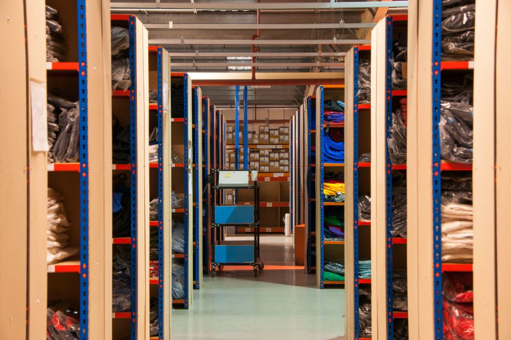 warehouse shelves with school uniform on them
