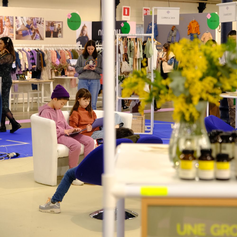 People sat and stood at a trade show 