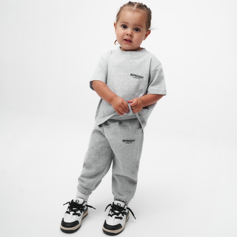 Young child wearing a great T-shirt and grey sweatpants by Represent 