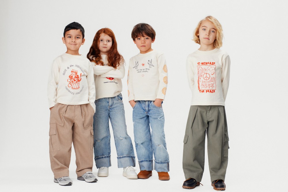 Four children stood in white tops and jeans