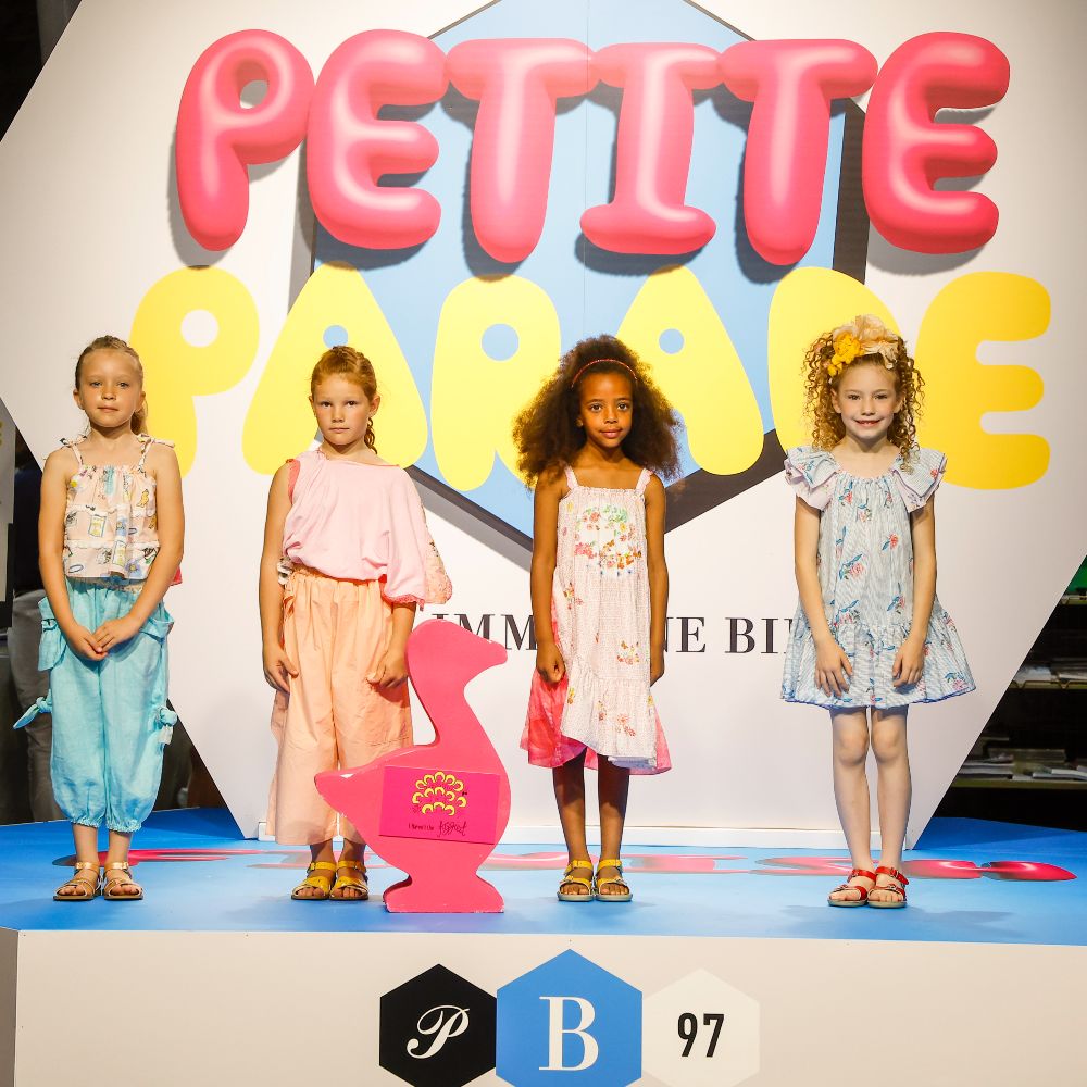 Four children stood on a stage at Pitti Bimbo 