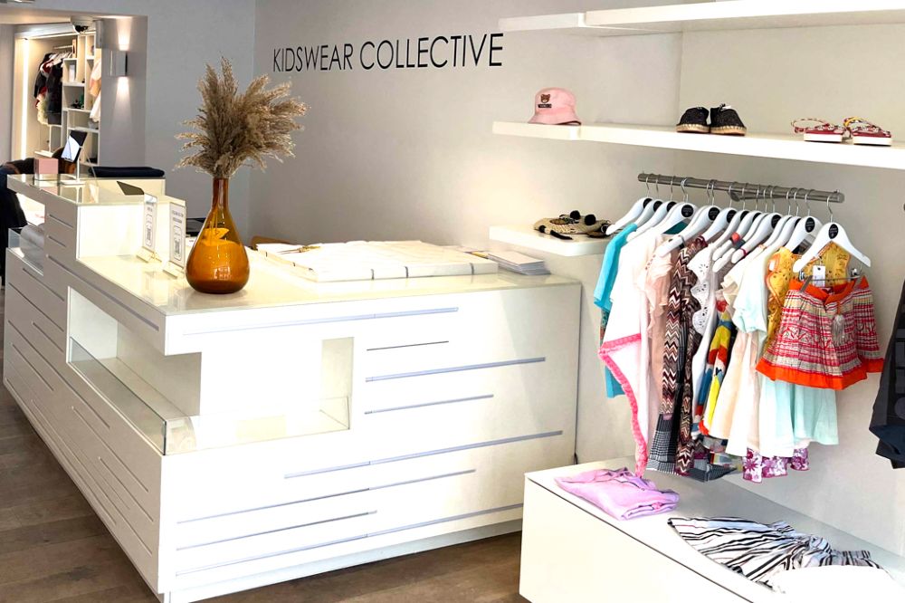 A counter and rail of children's clothing in the Kidswear Collective pop-up shop 