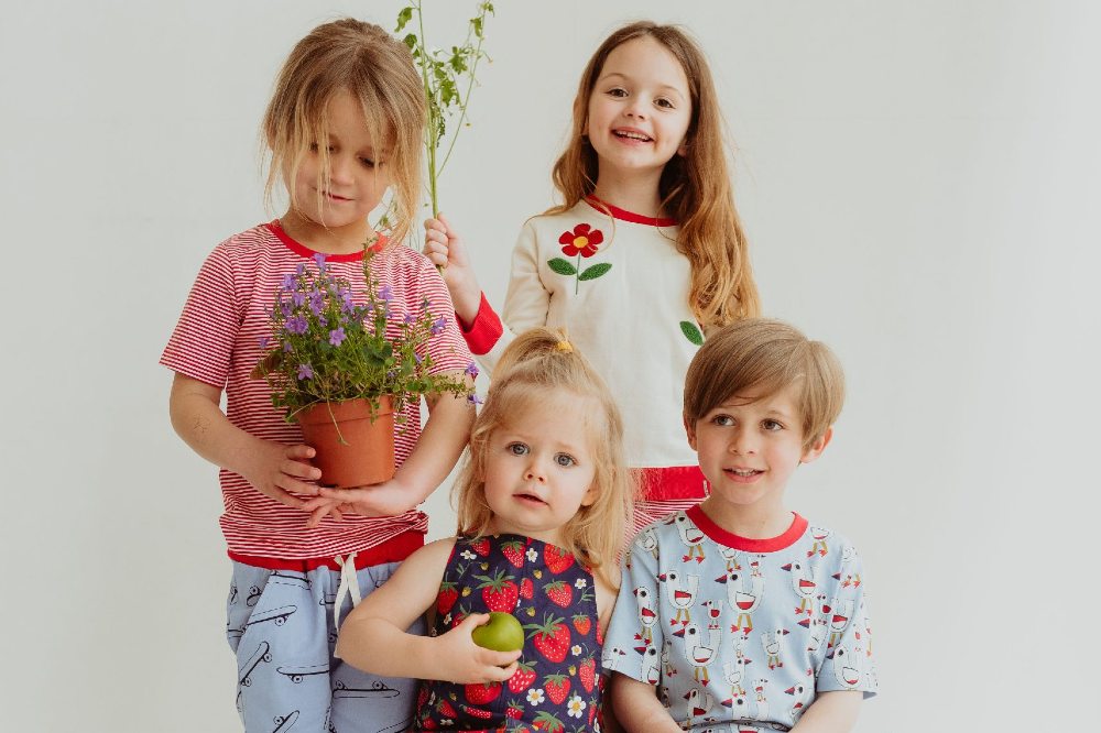 Four children wearing clothes by Lilly + Sid
