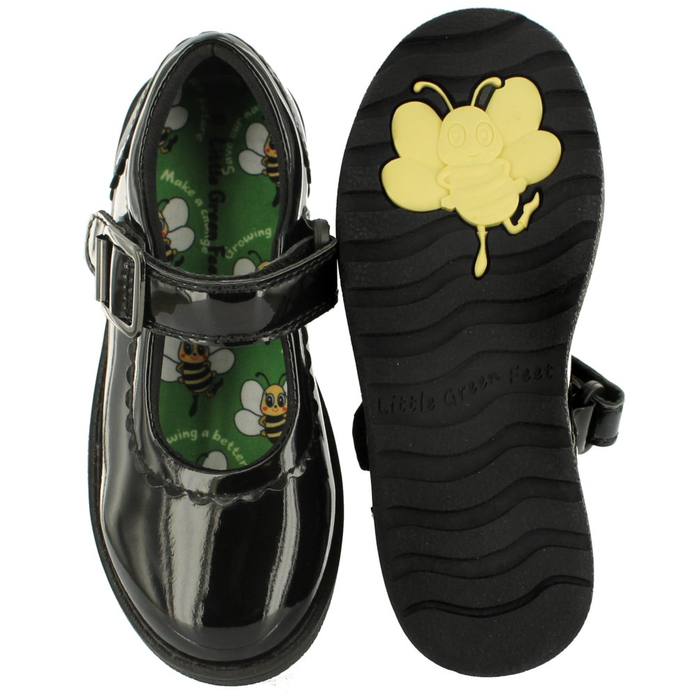 A pair of black patent school shoes with a yellow bee on the sole by Little Green Feet 