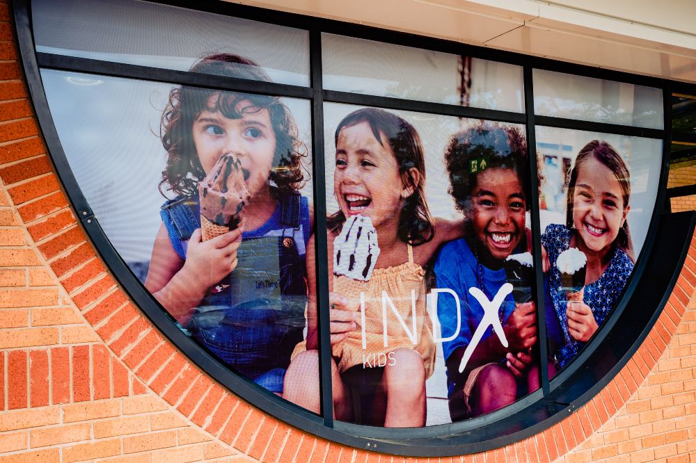 INDX Kids sign in a window