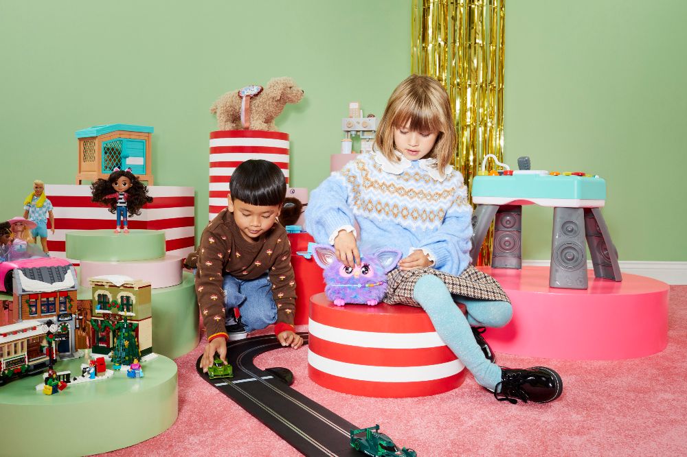 Two young children playing with a selection of toys