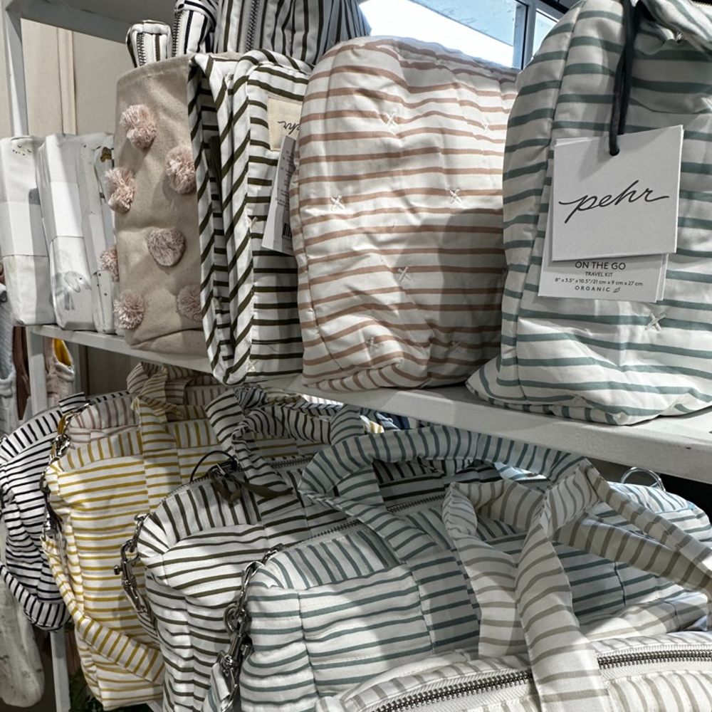 Large striped bags displayed on shelves 