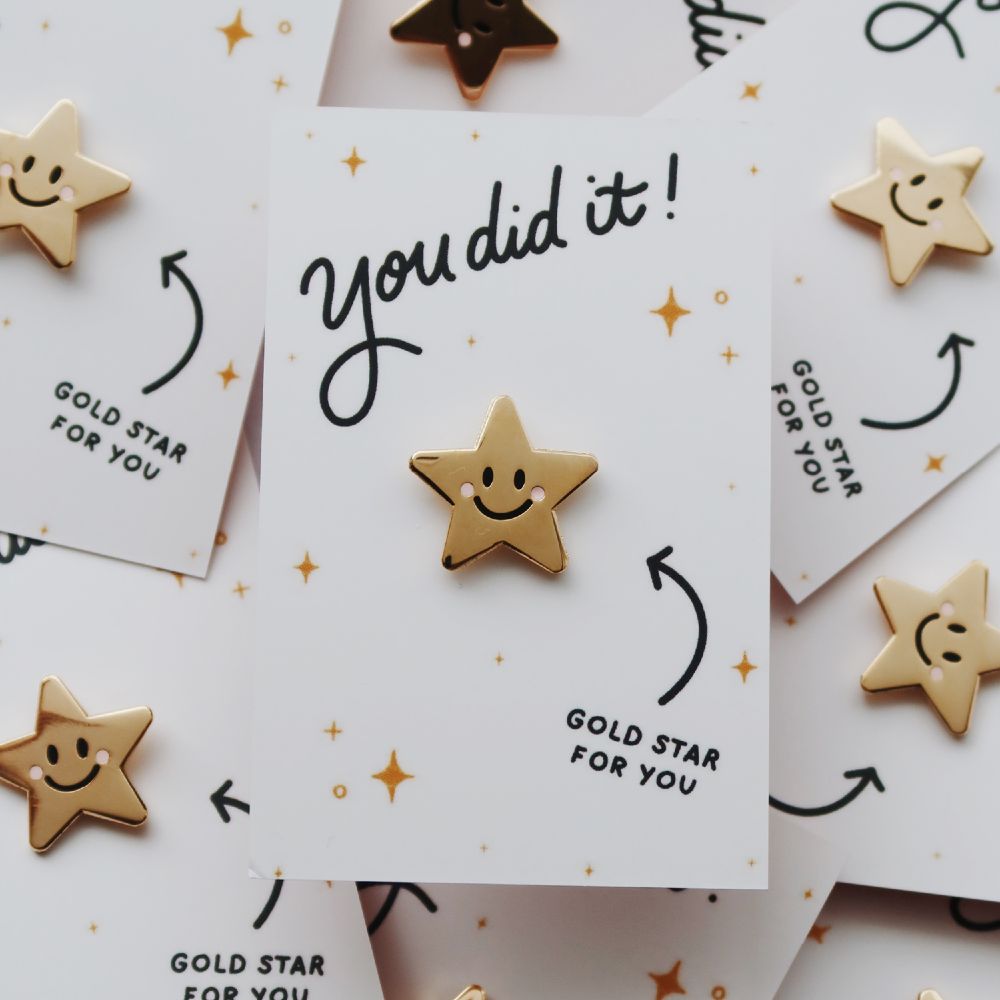 Gold pin badges on cards saying 'You did it!'