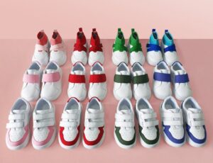Rows of children's trainers on a pink background