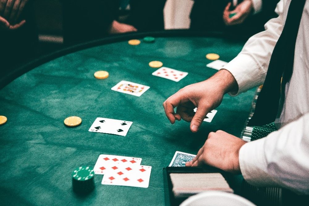 A man dealing cards at a casino table
